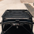 Load image into Gallery viewer, Black roof rack system on a vehicle with LED lights in an outdoor setting
