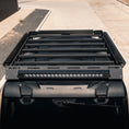 Load image into Gallery viewer, Black roof rack system on a vehicle with LED lights in an outdoor setting
